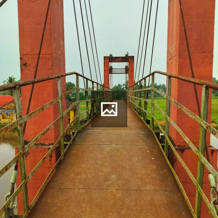 Old red bridge with rusty rail