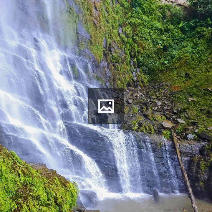 Waterfall in rocky greenery