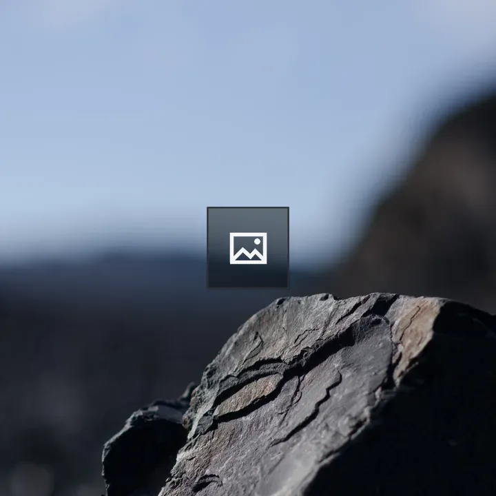 Dark rock against blue sky