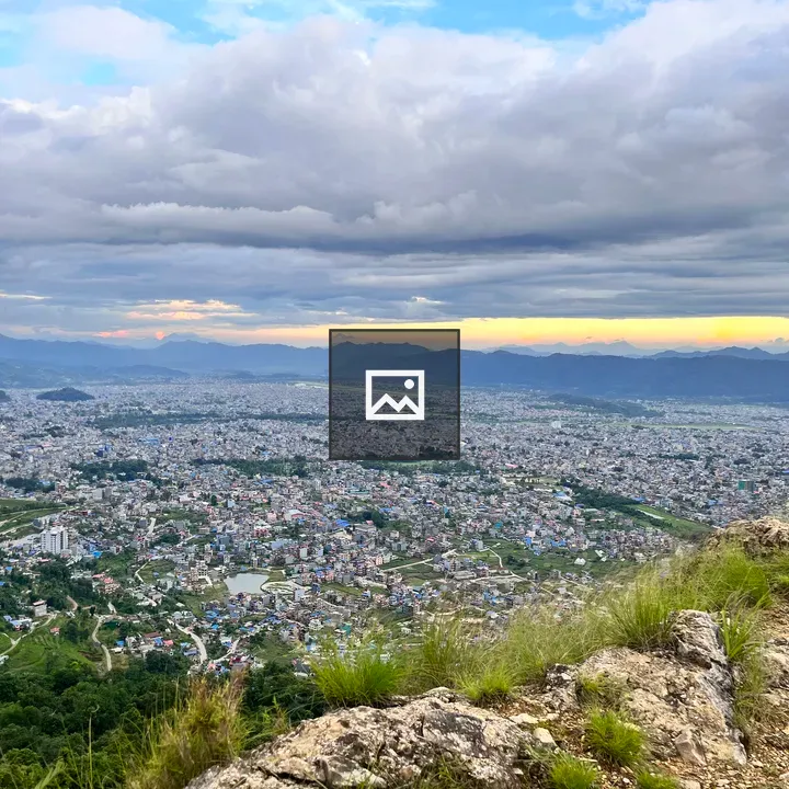 Cityscape at Sunset with Hills