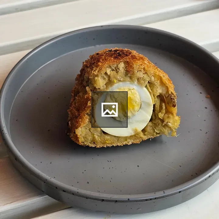 Halved Scotch Egg on Plate