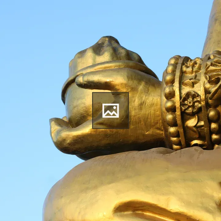 Hand of golden statue holding bowl
