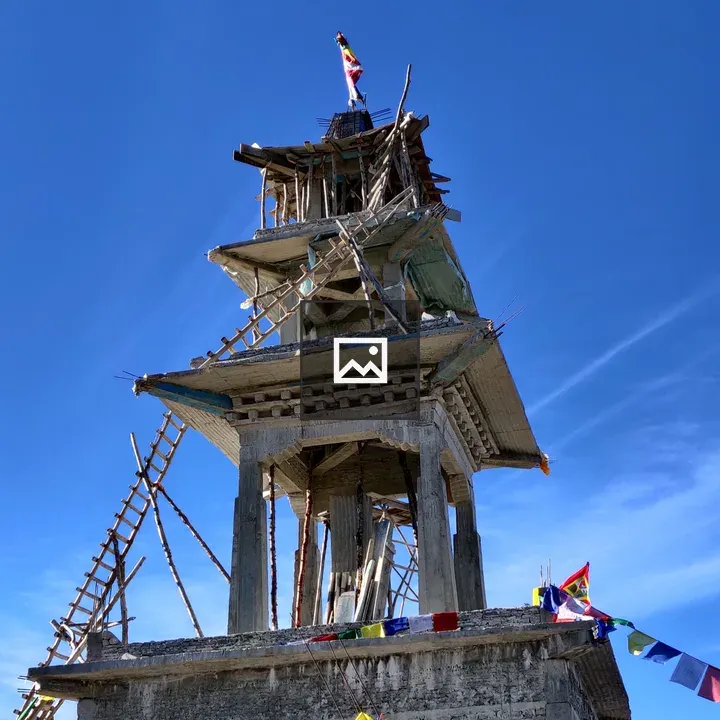 Temple under construction with prayer flags