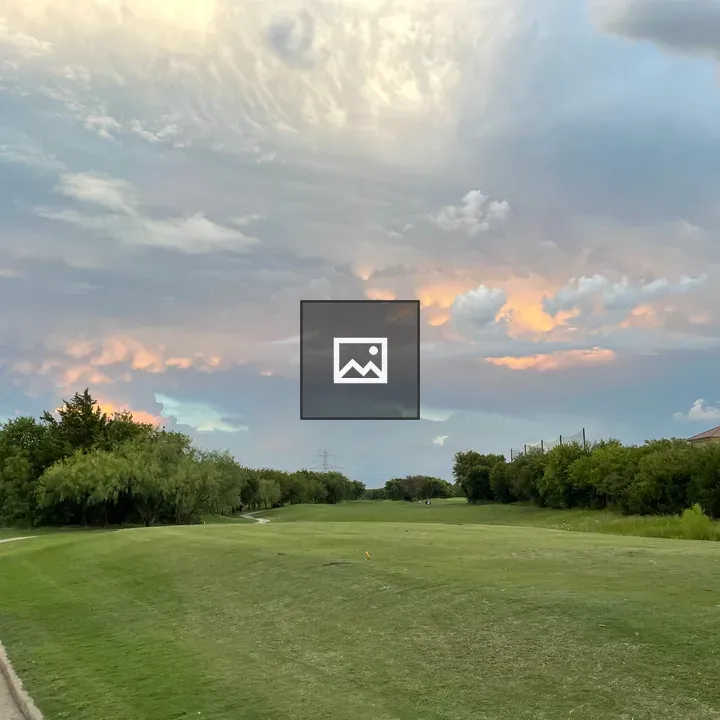 Colorful evening sky over golf course