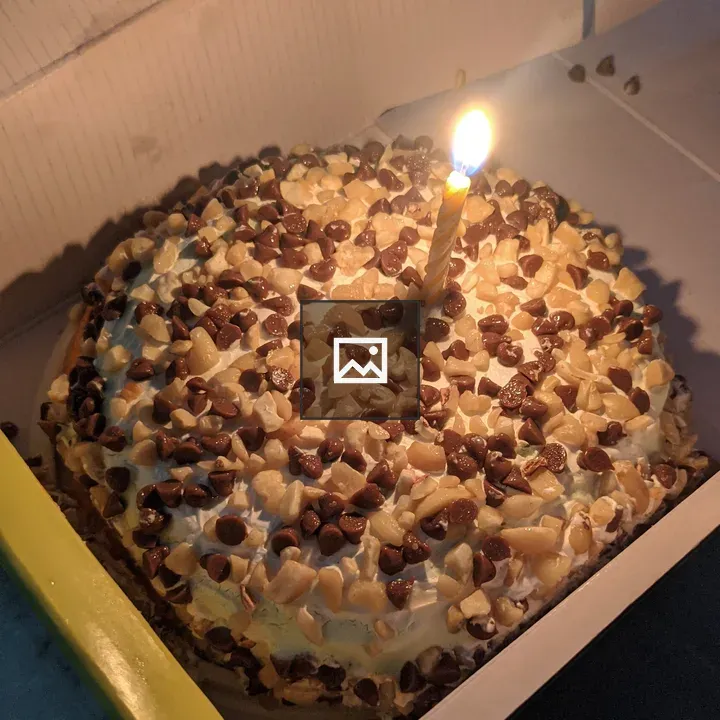 Birthday cake with lit candle