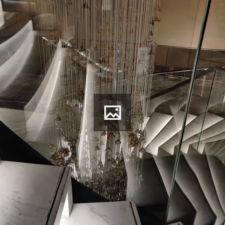Staircase with Marble Steps and Chandelier