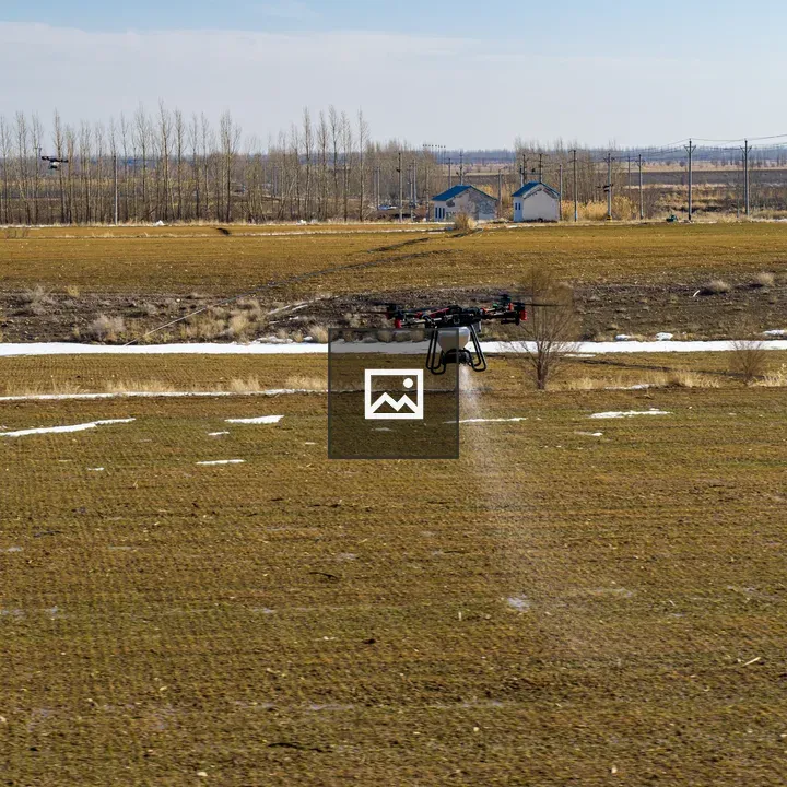 Drone over grassy field spraying