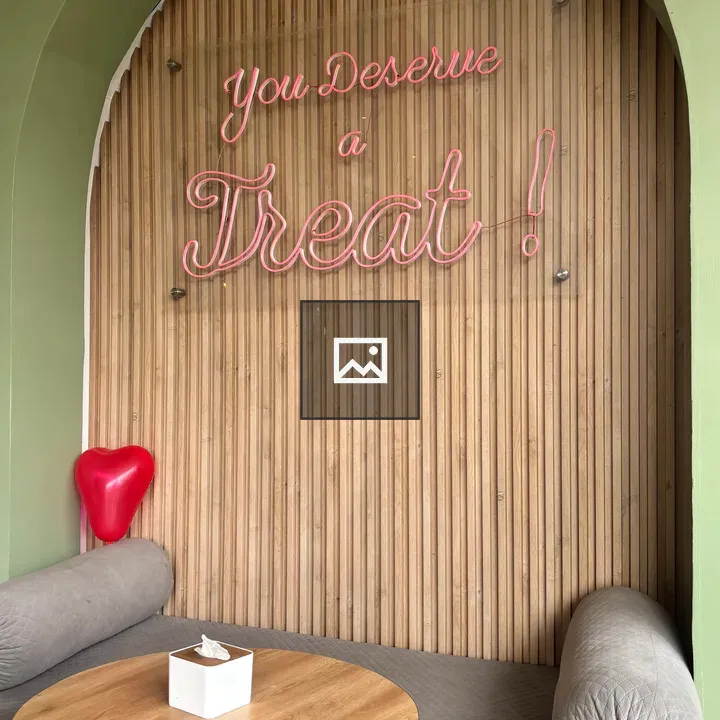 Cozy seating area with pink neon sign