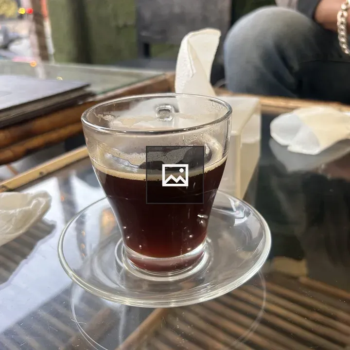 Coffee in glass cup on saucer