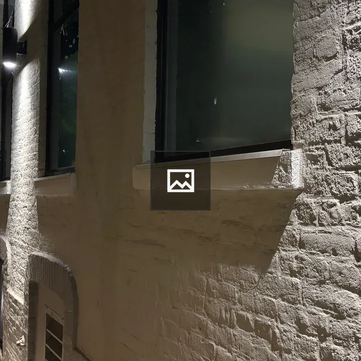 Night sidewalk with wall and lights