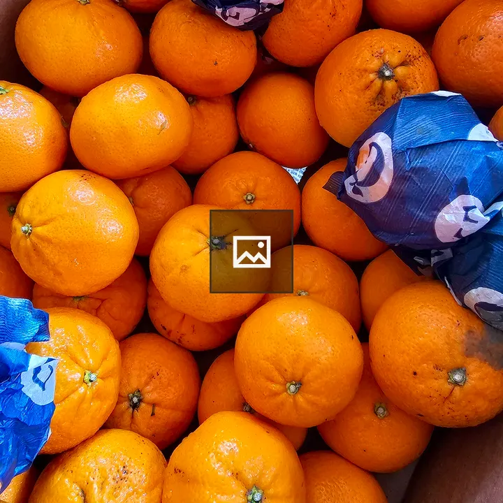 Bright orange oranges in a box