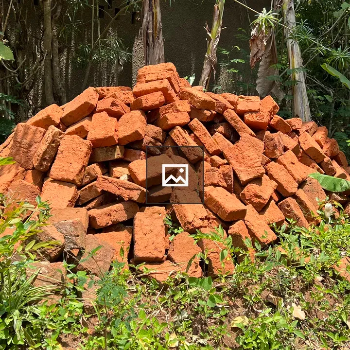 Pile of red bricks in garden