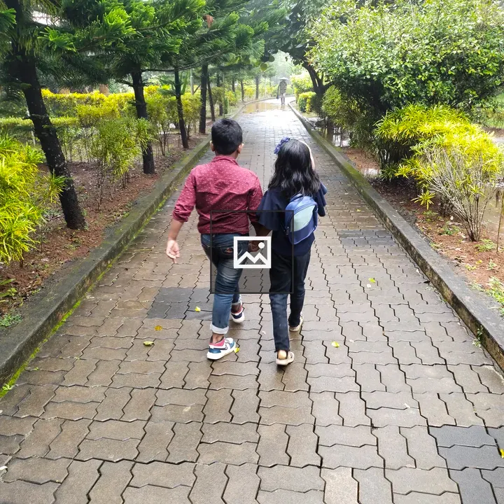 Two Children Walking in Park