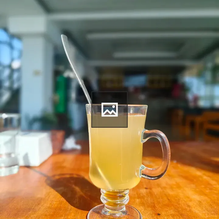 Glassy mug with yellow beverage