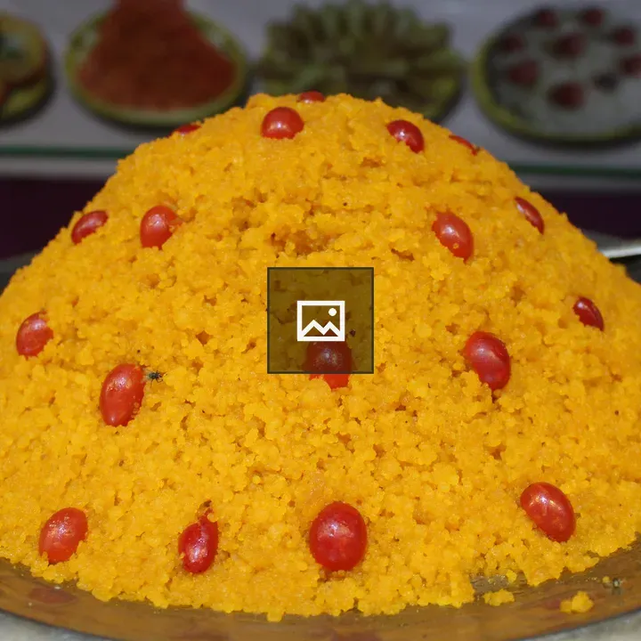 Mound of orange grains with dried fruits