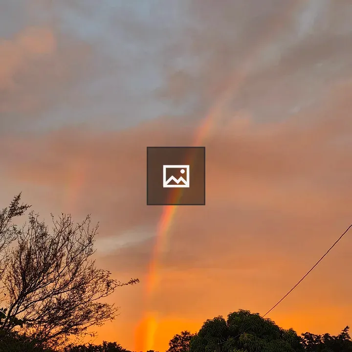 Rainbow Over Sunset Sky