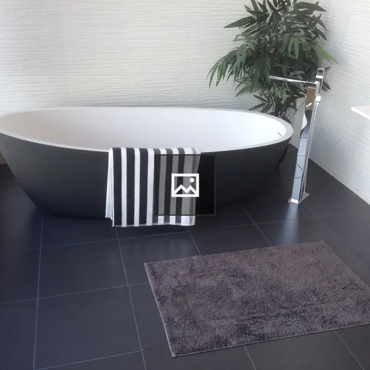 Bath with towel and plant