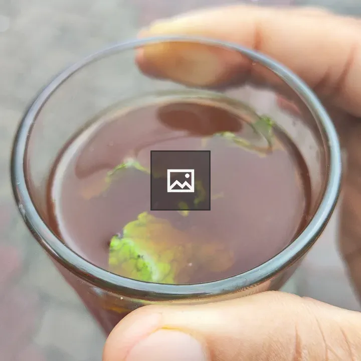 Person with Glass of Green Tea
