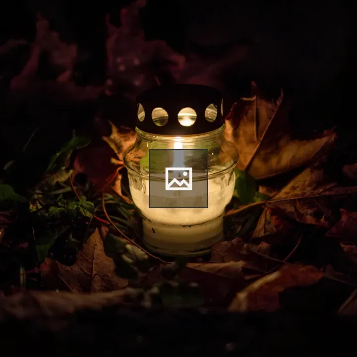 Candle on orange leaves