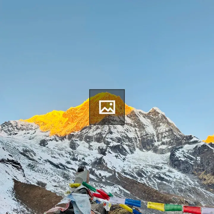 Snowy mountain peak with prayer flags