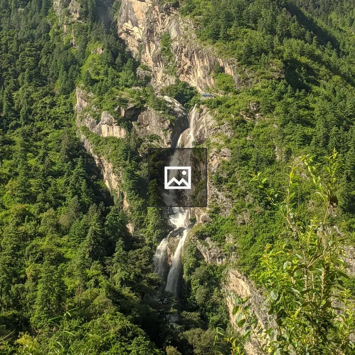 Waterfall Over Green Mountain Landscape