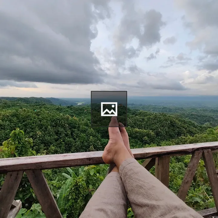 Bare feet on wooden railing
