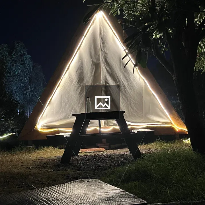 Cozy triangular tent at night