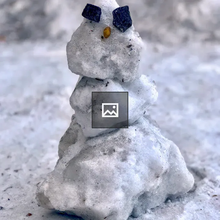 Tiny snowman of ice and rocks