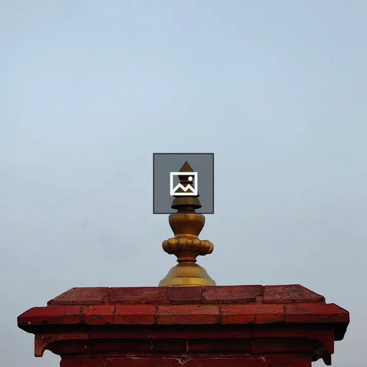 Red brick temple with ornate finial