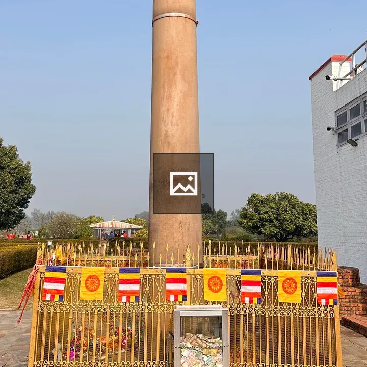 Tall cylindrical pillar with decorative fence