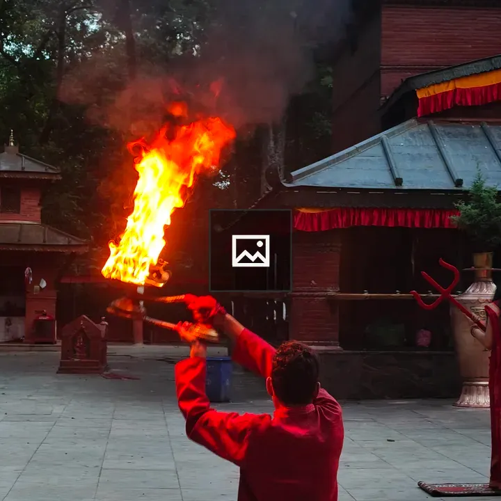 Person in Red Traditional Outfit with Torch