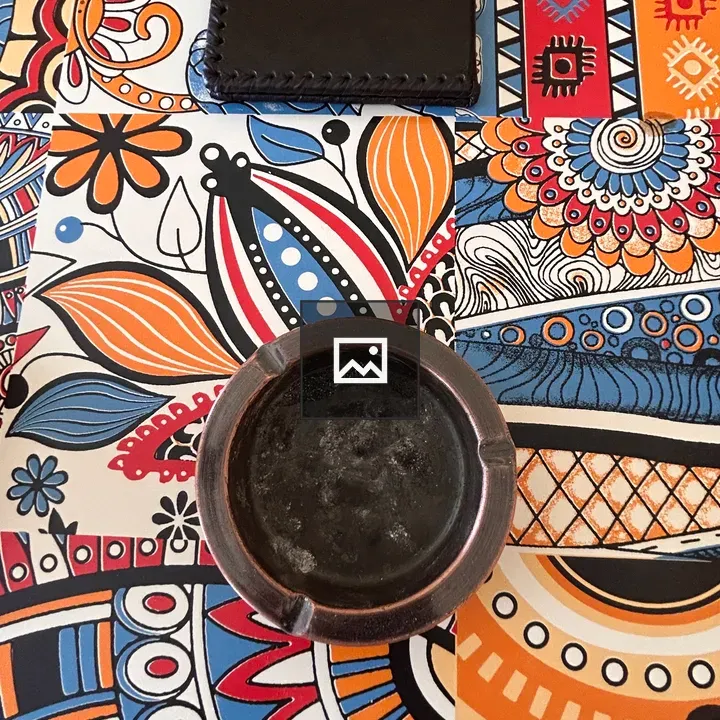 Colorful tablecloth and ashtray