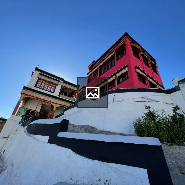 Red building on hill with staircase