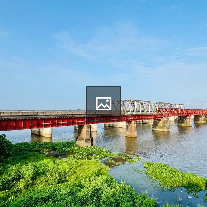 Red and grey truss bridge over river