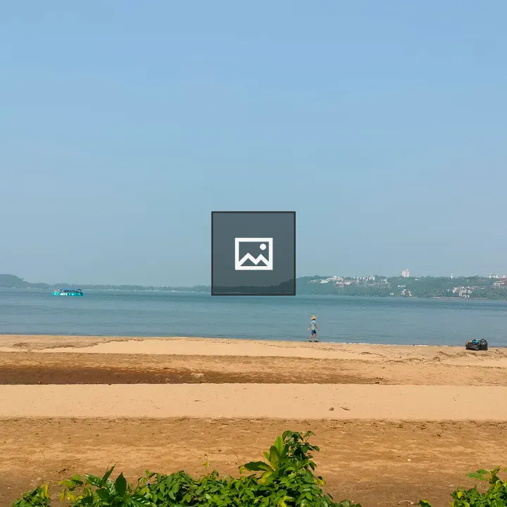 Beach scene with boat and walker