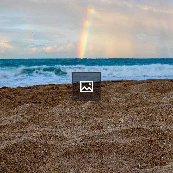 Rainbow over sandy beach
