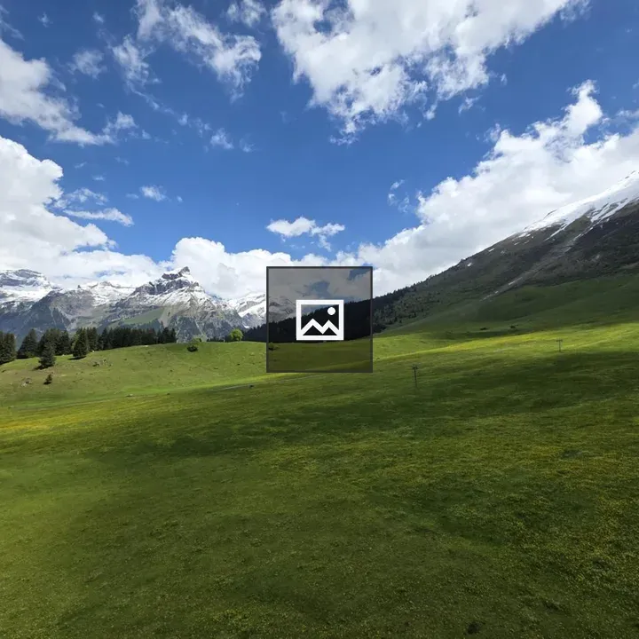 Green hills and snow-capped mountains