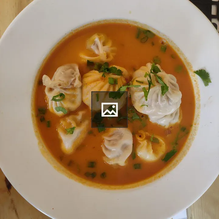 Dumplings in orange broth