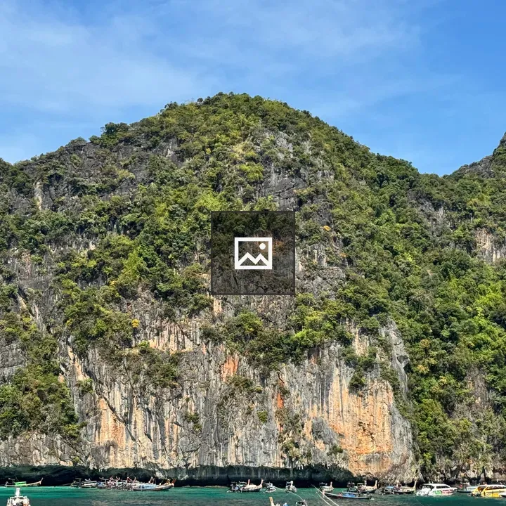 Limestone Cliff with Thai Longtail Boats