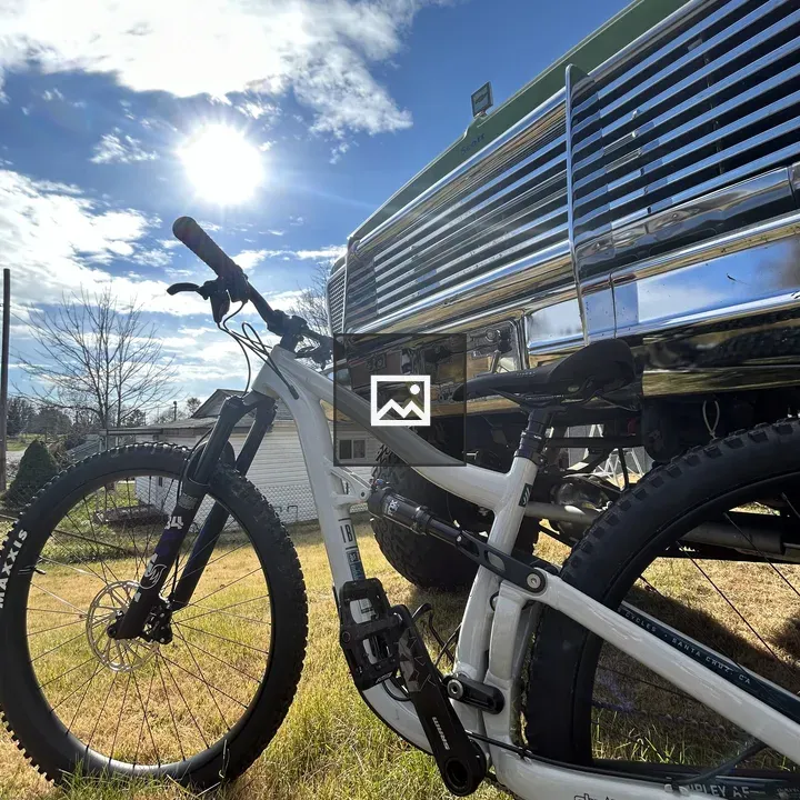 White mountain bike near green antique truck