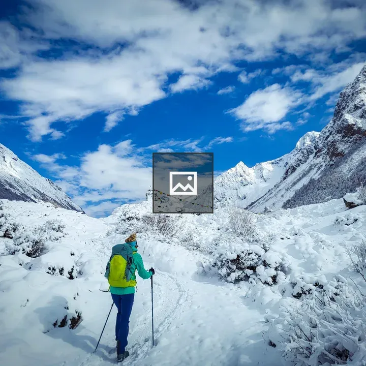 Person Hiking in Snowy Mountain Landscape