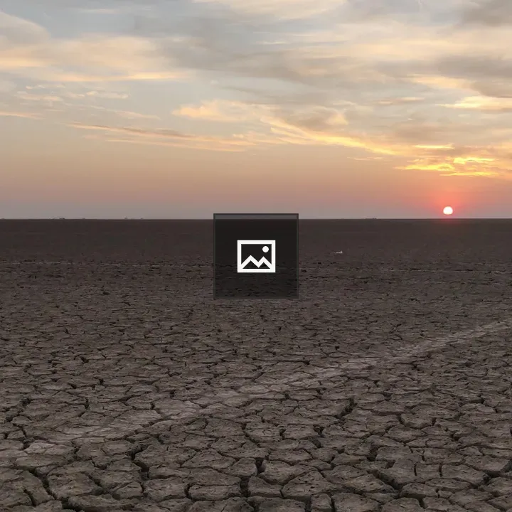 Sunset over cracked desert clay