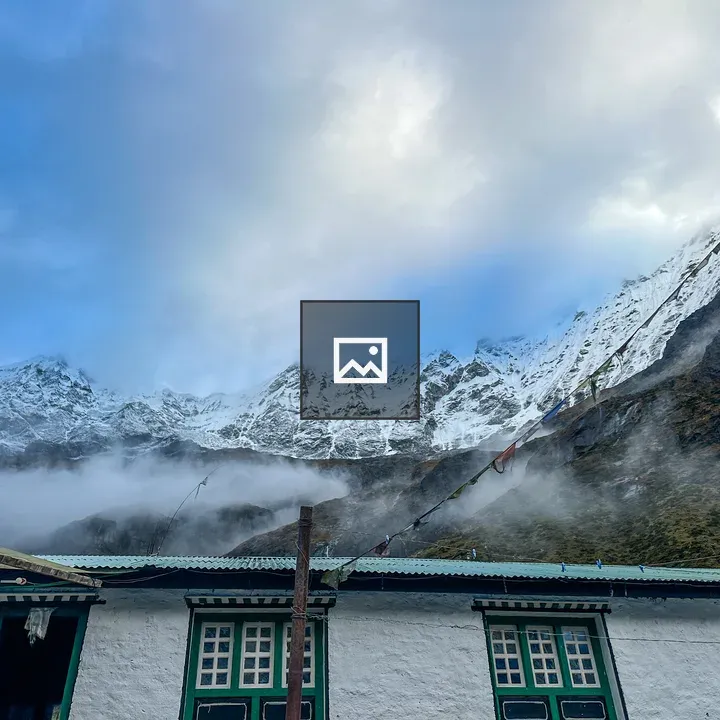 Snowy mountains with building and flags