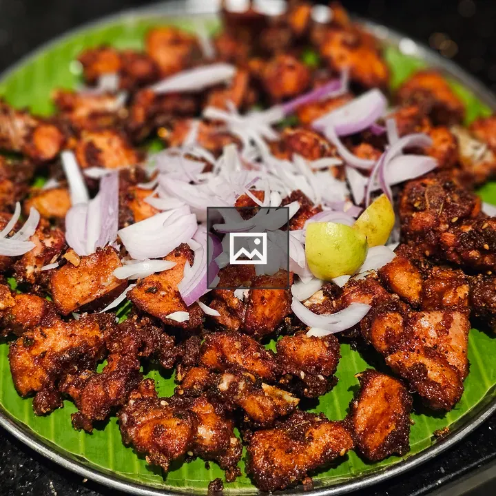 Spicy fried chicken on banana leaf