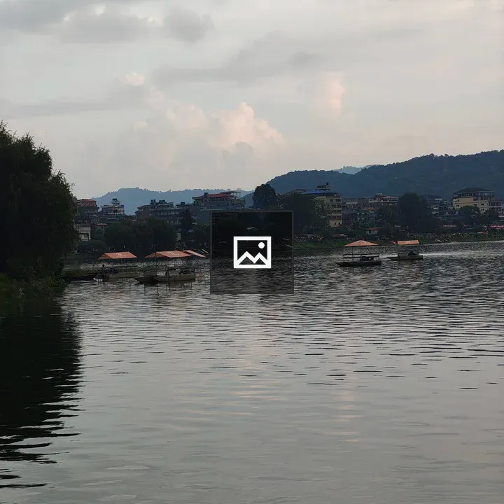 Serene lake with boats and hills