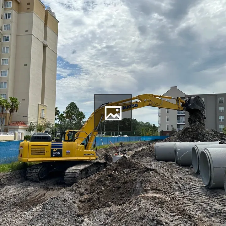Komatsu excavator laying pipes