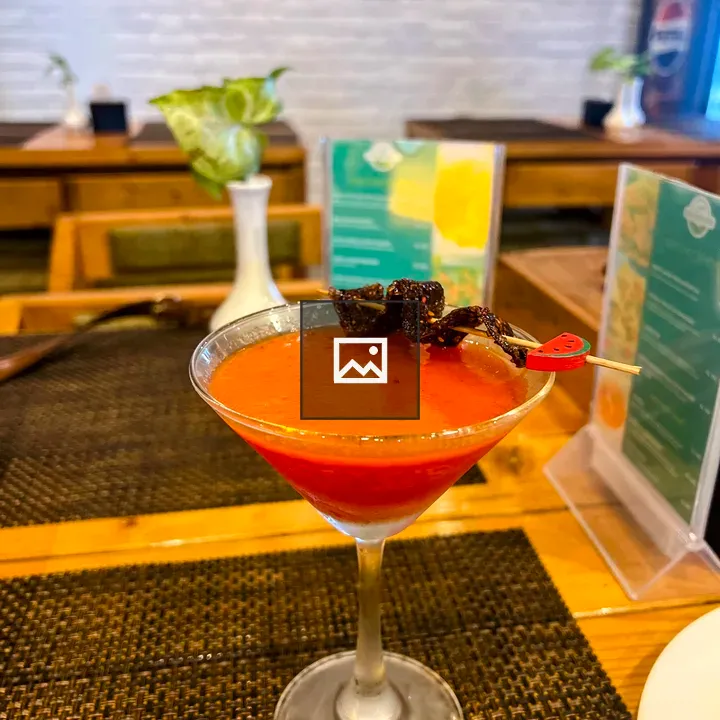 Martini Glass with Orange-Red Cocktail