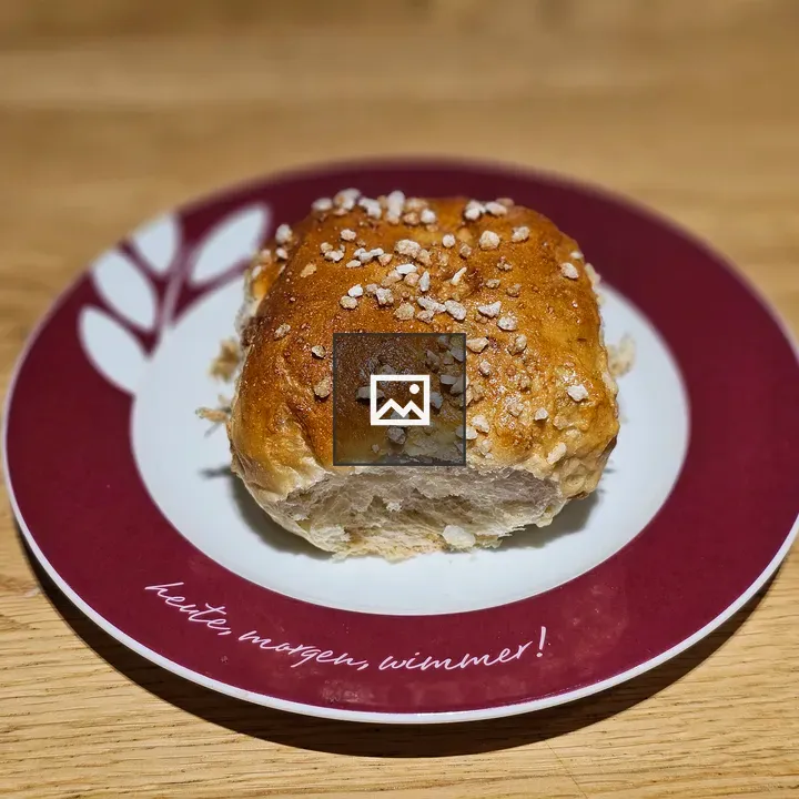 Bread roll on red plate