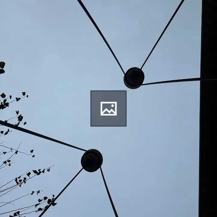 View of sky with two spheres held by pillars