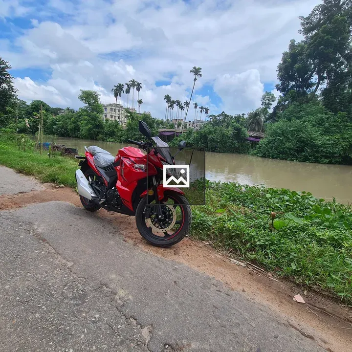 Red motorcycle by river road